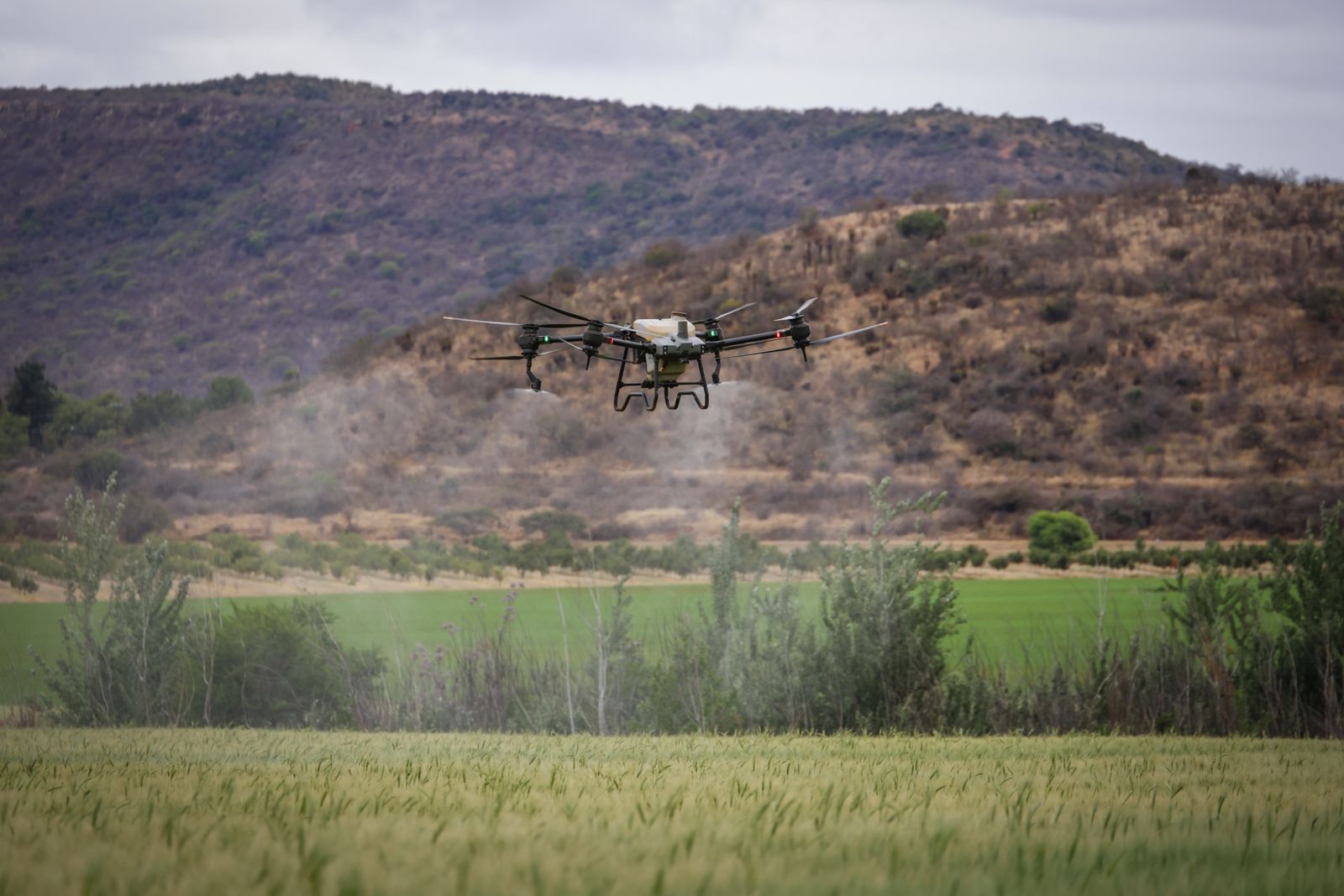 Agricultural drone spraying over a green farm field — a key demand in Nigeria